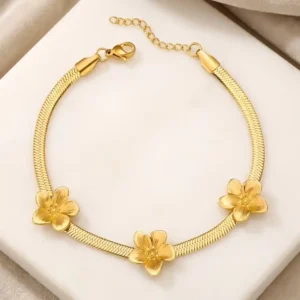 Pulseras para damas estilo flexible tipo malla con apliques de flores de acero y bañada en oro 18k